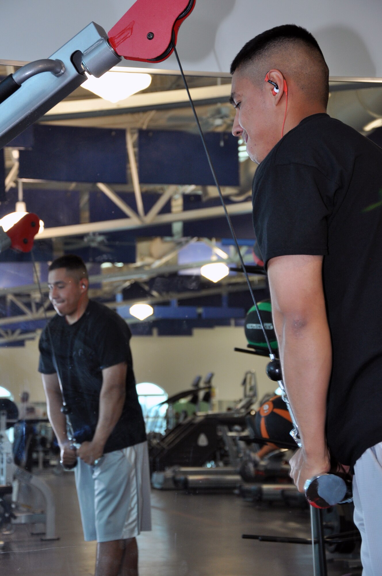Airman 1st Class Javier Duran Gutierrez, 90th Missile Security Forces Squadron, works his triceps in Freedom Hall Fitness Center Oct. 30. Duran Gutierrez uses the exercise facility on base every morning to stay healthy and fit to fight. (U.S. Air Force photo by Senior Airman Dan Gage)