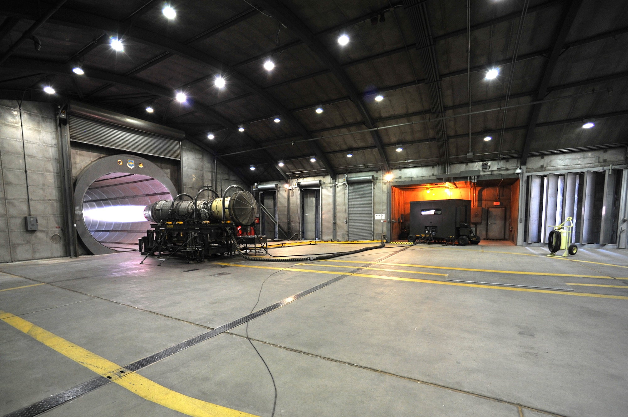 Test cell technicians run an engine in full afterburner at hush house two at Luke Air Force Base. The technicians check the oil pressure, core speed, fan speed and temperature during an engine run. (U.S. Air Force photo by Senior Airman Sandra Welch)