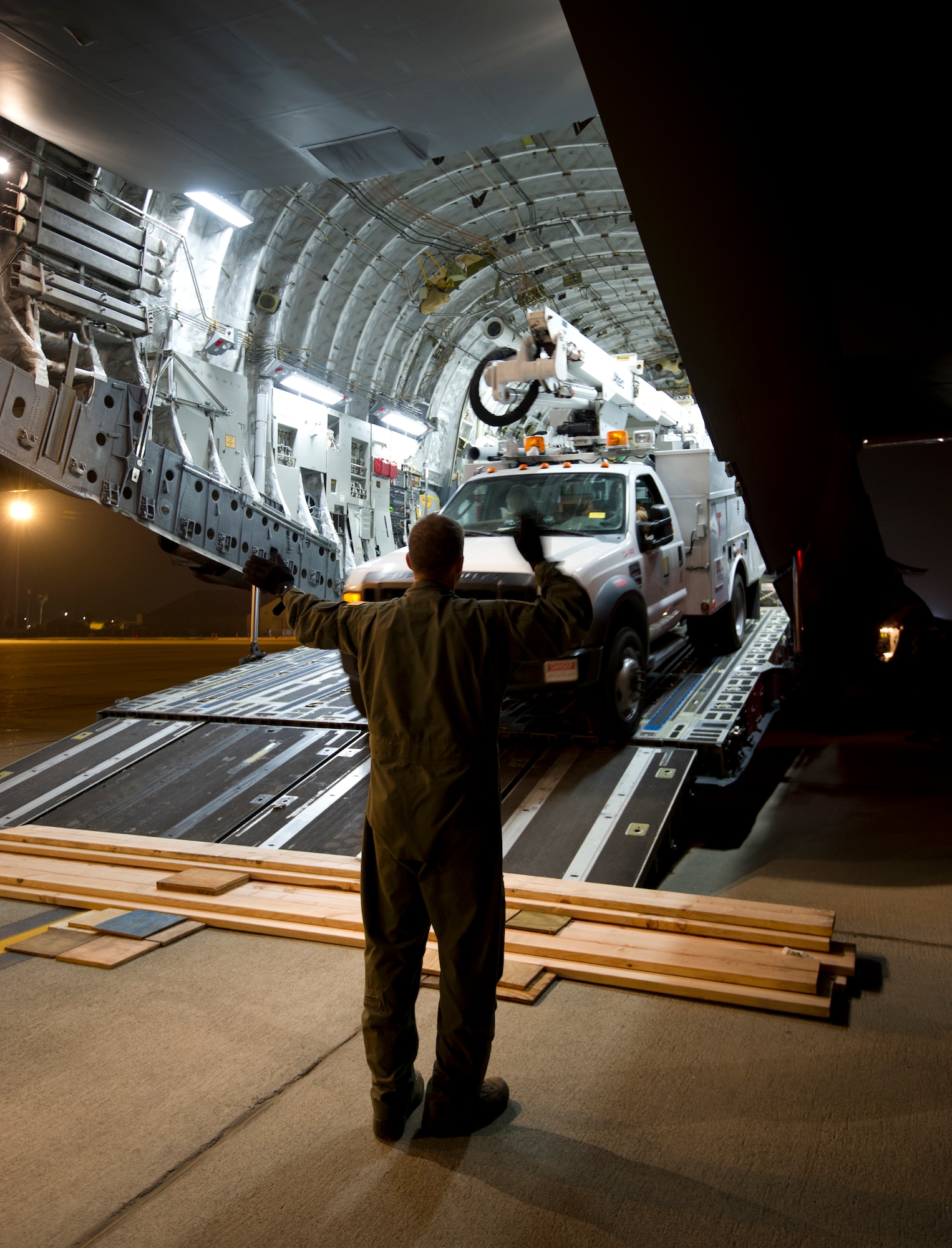 Tech. Sgt. Jeffrey Burke, 137th Airlift Squadron loadmaster, directs a Southern California Edison utility vehicle as it is loaded onto a C-17 Globemaster III at March Air Reserve Base, Calif., Nov. 1, 2012. Military bases across the nation are mobilizing to the northeast region of the country to restore electricity and provide humanitarian assistance, as currently more than two million people are without power. (U.S. Air Force photo/Staff Sgt. Caroline Hayworth)