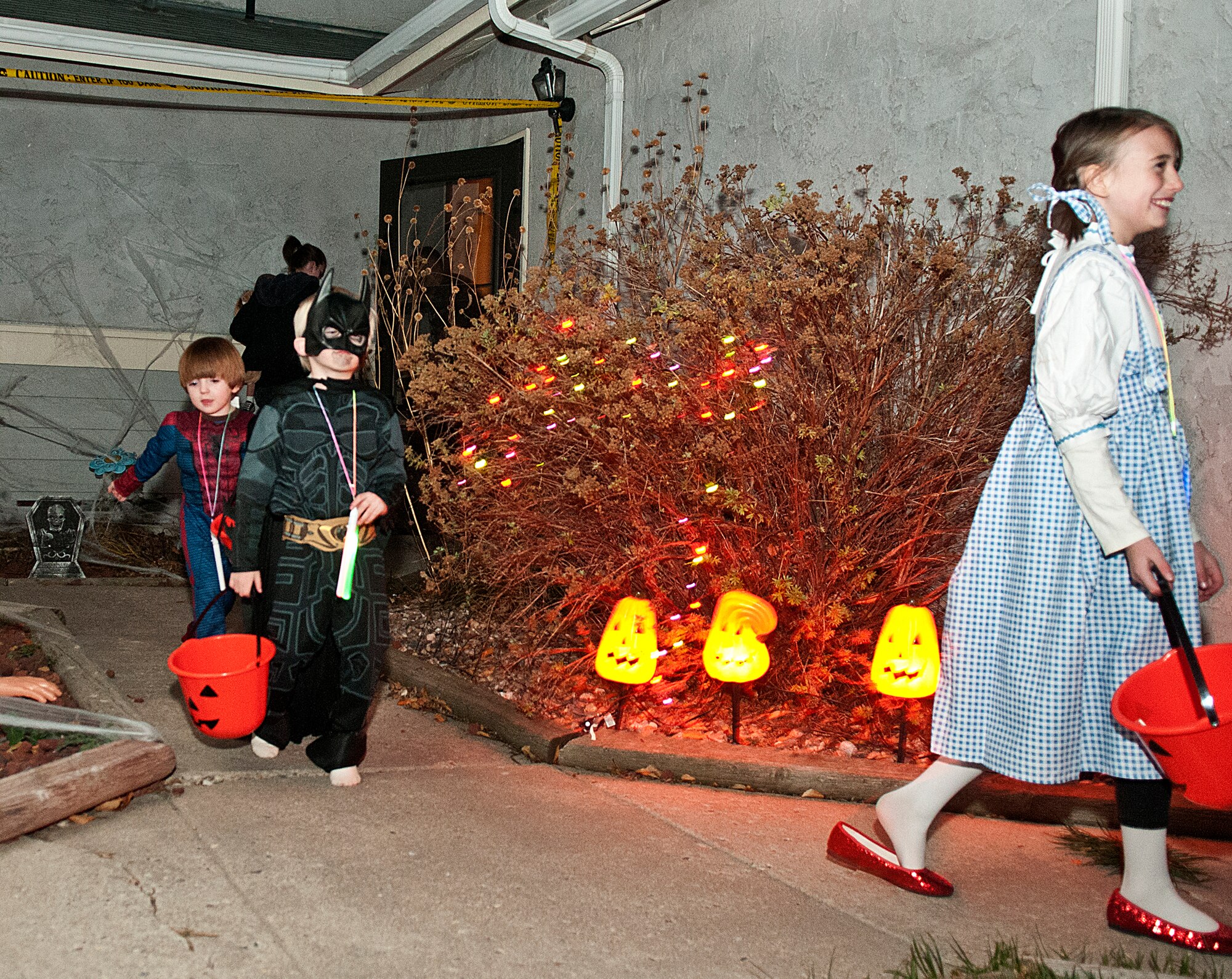Alyssa, 9, Gavin, 6, and Jeremiah, 6, Vincent trick-or-treat along Minuteman Drive, one of F. E. Warren's housing areas on Halloween. The Vincents are the children of Porshia and Senior Airman Gary Vincent, 90th Missile Maintenance Squadron. (U.S. Air Force photo by R.J. Oriez)