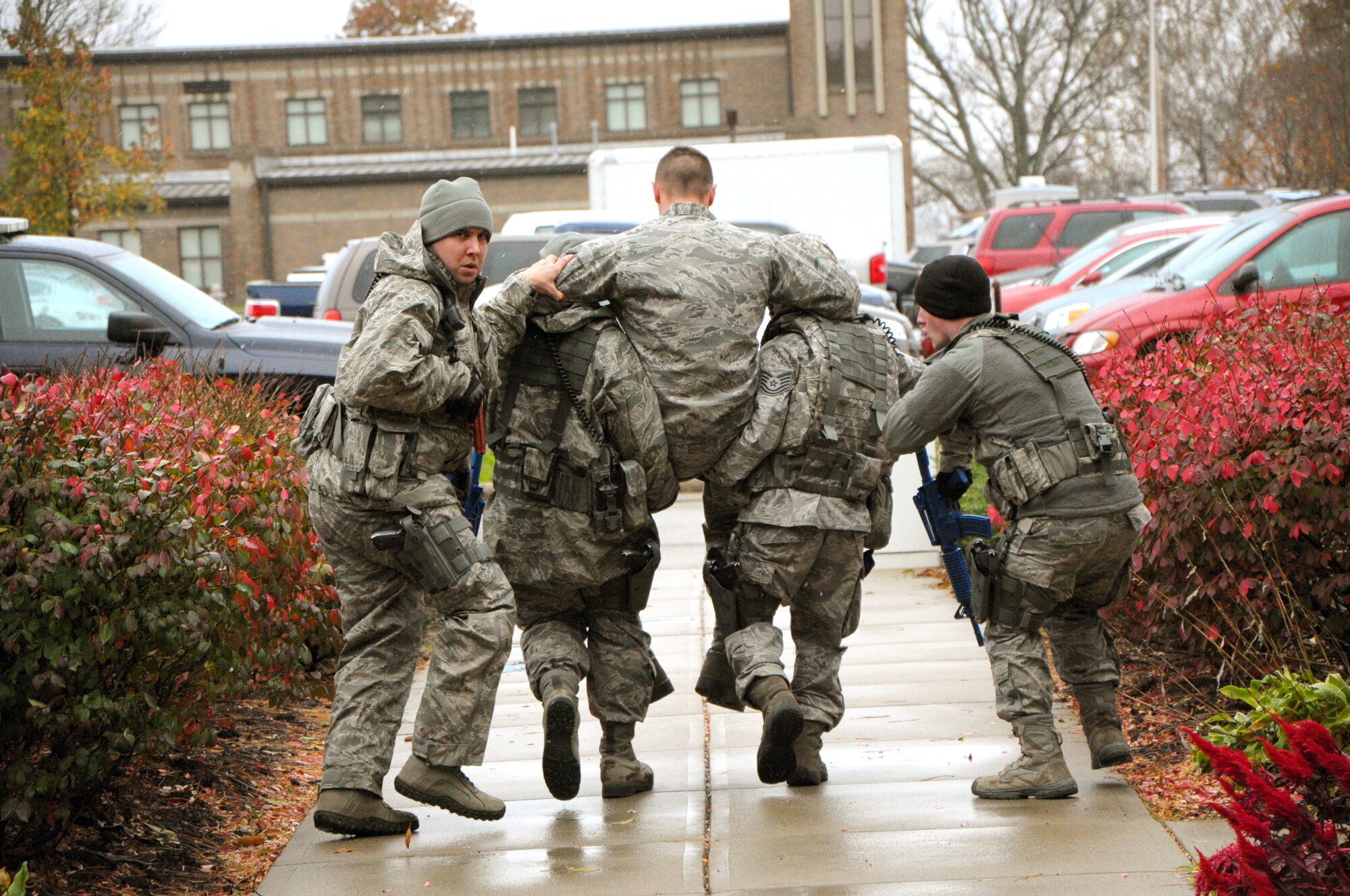 A Security Forces recovery Team remove an ‘injured’ employee from the building during the active shooter exercise.  (photo by Niki Jahns)
