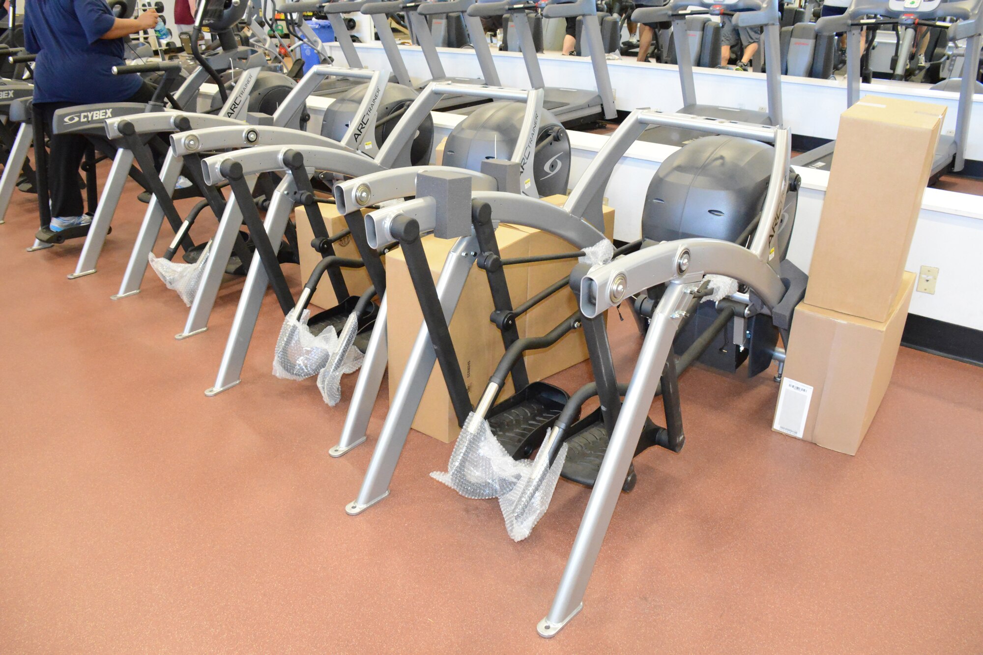 New ARC trainers, which are a cross between elliptical and step machines are lined up prior to installation. (U. S. Air Force photo/Ed Aspera)