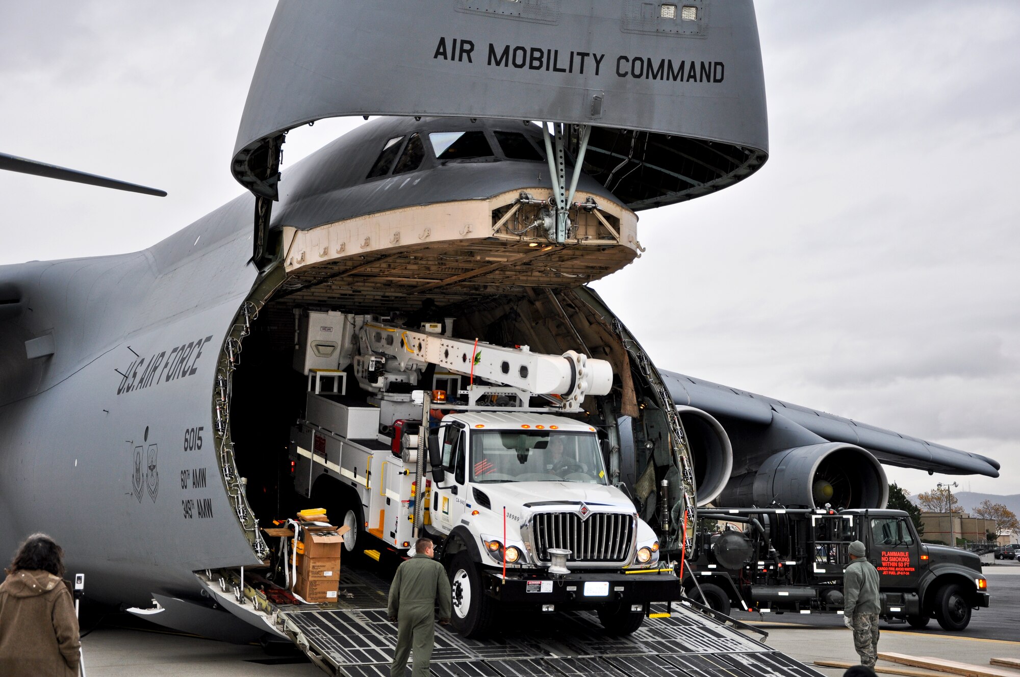 Air Force crews offload Southern California Edison power repair equipment from a C-5 Galaxy on Stewart Air National Guard Base in Newburgh, N.Y., Nov. 1, 2012. The Defense Department initiated the airlift operation to aid recovery efforts in Hurricane Sandy's aftermath. (U.S. Army photo/Master Sgt. Corine Lombardo)