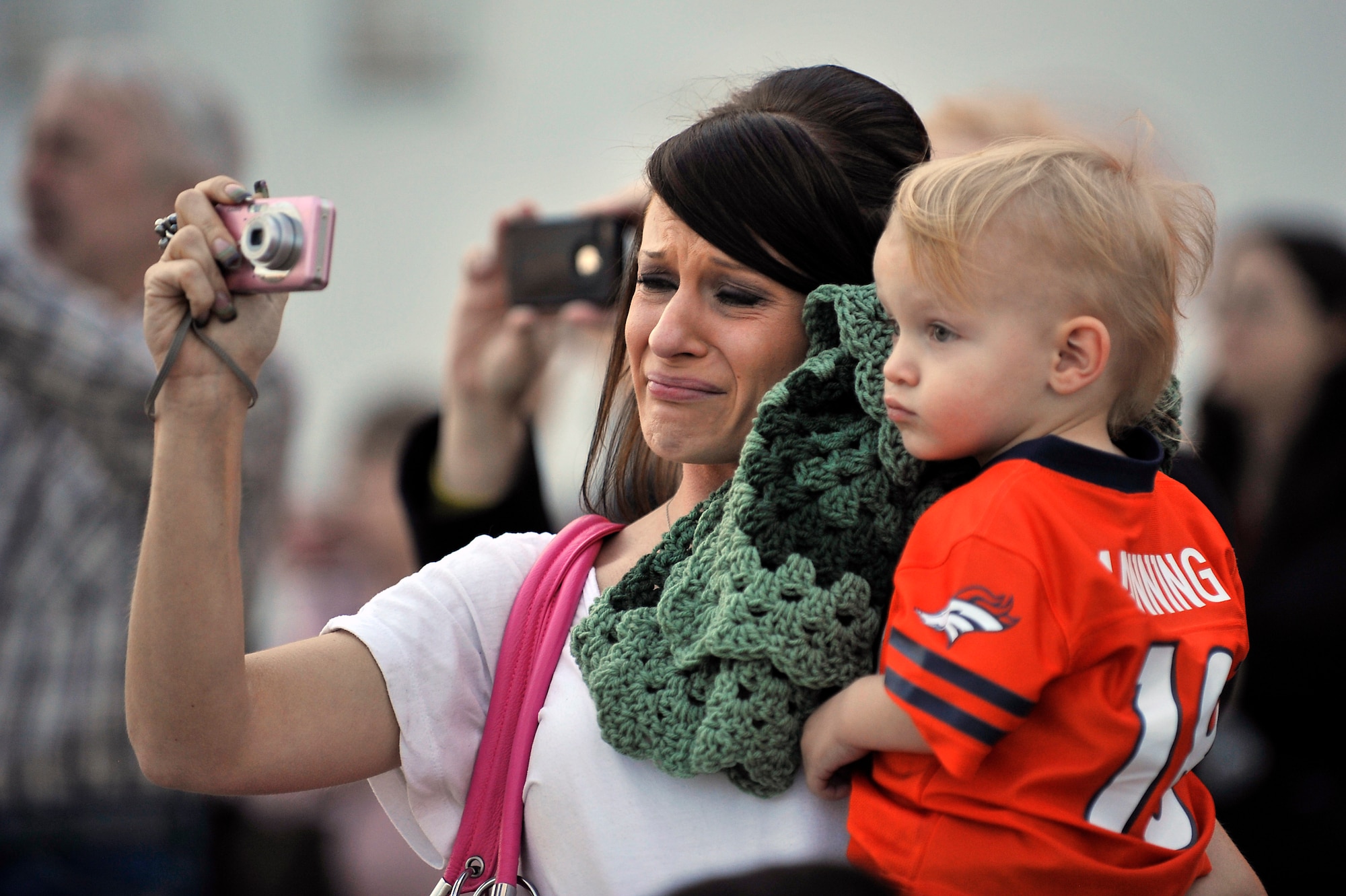 Ms. Amanda Palmer and her son, Brayden watch as her husband, U.S. Air Force Staff Sgt. Michael Palmer, 140th Maintenance Squadron, takes off for a deployment at Buckley Air Force Base Colo., Nov 1, 2012.  Members of the 140th Wing, Colorado Air National Guard, have been taking off from Buckley AFB, Colo. this week, headed to a forward operating location in support of Air Force Central Command. These pilots, aircraft maintainers and support personnel will be deployed throughout the holiday season in order to support the ongoing Overseas Contingency Operations. (Colorado Air National Guard photo by Tech. Sgt. Wolfram M. Stumpf)