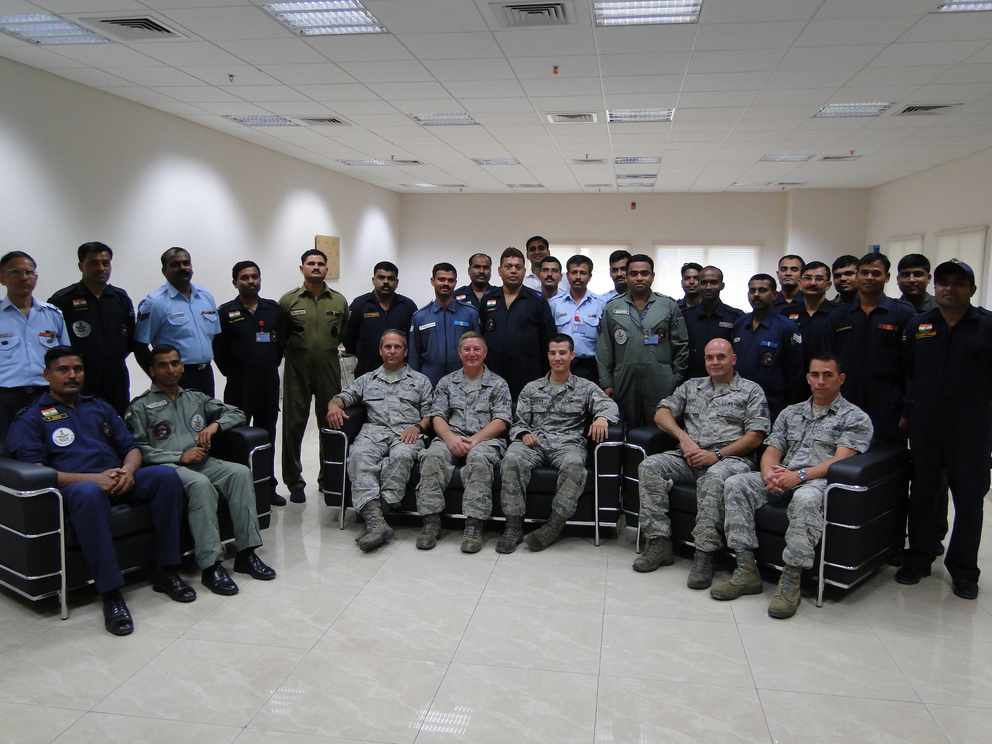 Master Sergeant Joe Delfino, Technical Sergeant Kevin Hunt, Staff Sergeant Matt Elderkin, Chief Master Sergeant Carlos Moniz and Captain Chris Peloso, all of the 143d Maintenance Group and members of the Mobile Training Team for the Indian Air Force, pose with some of their students. Provided photo.