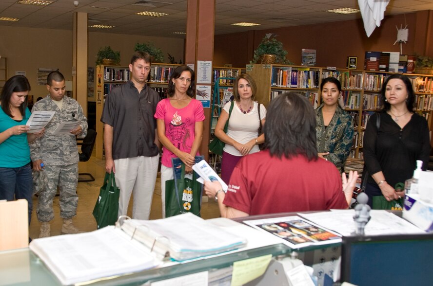 Military spouses receive a tour and brief of the Coalition Compound's Learning and Resource Center during the Command Sponsorship Program family dinner Oct. 25, 2012. The event was designed to give families a chance to see and tour many of the facilities available to them located throughout the base. After the conclusion of the tour, the families gathered at Kimbolton Hall in the BPC Mall for a social gathering and dinner. (U.S. Air Force photo/Senior Airman Bryan Swink)