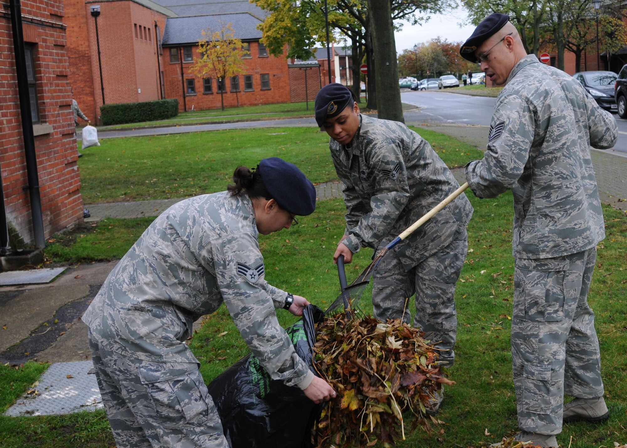 Patrolmen from the 100th Security Forces Squadron participate in Base Cleanup Day Nov. 1, 2012, on RAF Mildenhall, England. Base Cleanup Day was a basewide effort to clean up leaves and other debris that fell this fall. (U.S. Air Force photo by Airman 1st Class Kelsey Waters/Released)