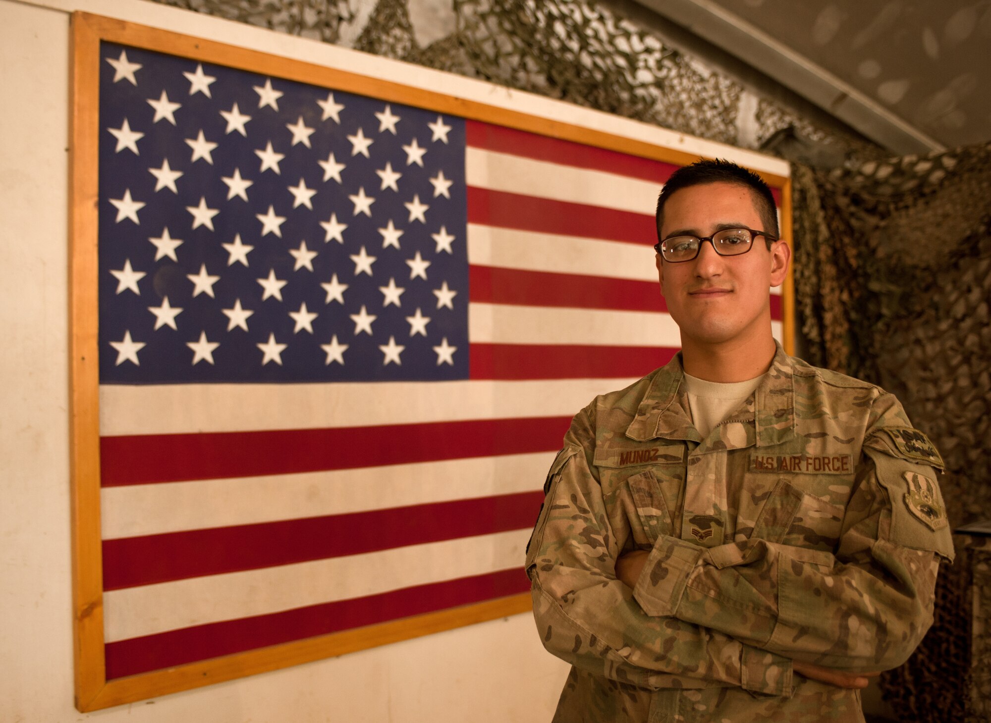 U.S. Air Force Senior Airman Edgar Munoz-Lopez, assigned to 455th Expeditionary Medical Operations Squadron, poses for a photo after taking an oath of U.S. citizenship during a naturalization ceremony at Bagram Airfield, Afghanistan, Nov. 2. 31 members from the Army, Air Force and Marines swore an oath of U.S. citizenship. The Honorable James Cunningham, U.S. Ambassador to Afghanistan, presented the servicemembers with their citizenship certificates. (U.S. Air Force photo/Staff Sgt. Jeff Nevison)