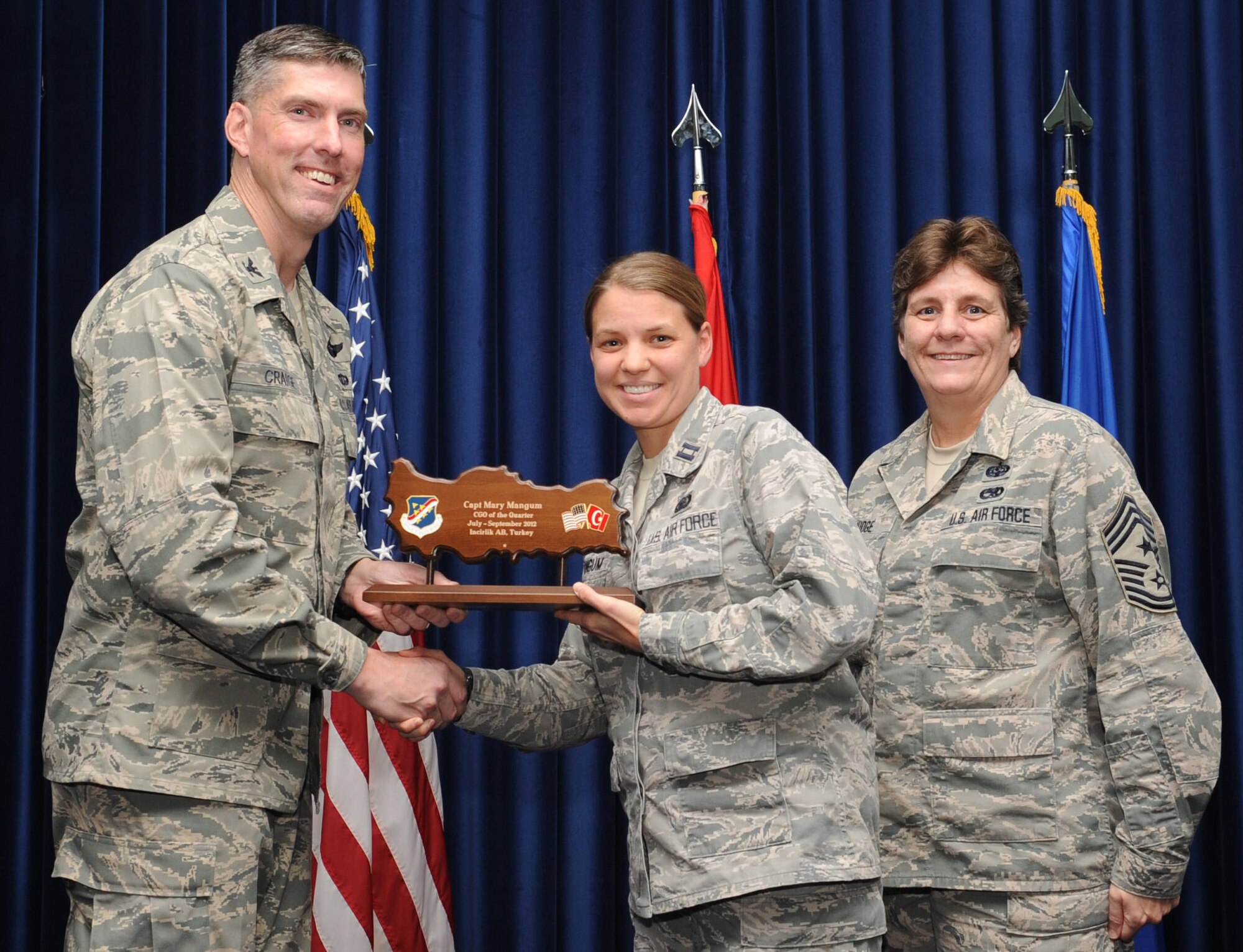 Capt. Mary Mangum, 39th Comptroller Squadron, is presented a Company Grade Officer of the Quarter Award at the club complex ballroom Oct. 31, 2012 at Incirlik Air Base, Turkey. Quarterly award and promotion ceremonies are a time-honored tradition across all branches of the armed forces. (U.S. Air Force photo by Senior Airman Daniel Phelps/ Released)