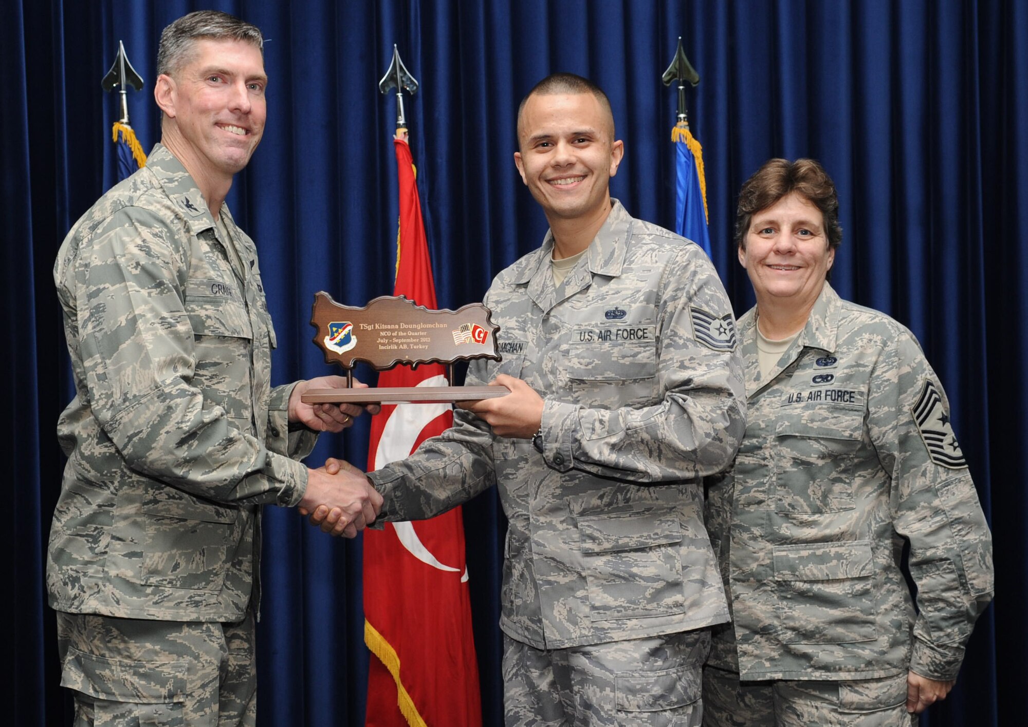 Tech. Sgt. Kitisana Dounglomchan, 39th Medical Support Squadron, is presented an NCO of the Quarter Award at the club complex ballroom Oct. 31, 2012 at Incirlik Air Base, Turkey. Quarterly award and promotion ceremonies are a time-honored tradition across all branches of the armed forces. (U.S. Air Force photo by Senior Airman Daniel Phelps/ Released)