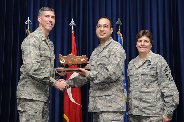 Airman 1st Class Eugenio Vives-Alvarez, 39th Communications Squadron, is presented an Airman of the Quarter Award at the club complex ballroom Oct. 31, 2012 at Incirlik Air Base, Turkey. Quarterly award and promotion ceremonies are a time-honored tradition across all branches of the armed forces. (U.S. Air Force photo by Senior Airman Daniel Phelps/ Released)