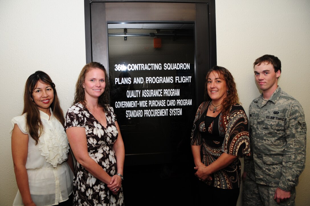 ANDERSEN AIR FORCE BASE, Guam -- Members of the 36th Contracting Squadron’s plans and programs flight stand beside their office entrance on Andersen Air Force Base, Oct. 23. The LGCP is a small team of professionals who work behind the scenes to support every unit within the 36th Wing. (U.S. Air Force photo by Senior Airman Benjamin Wiseman/Released)