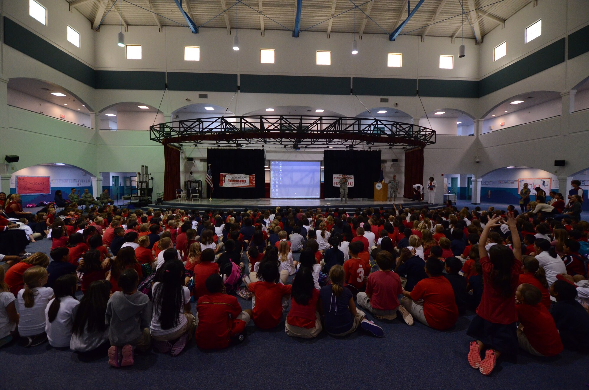 ANDERSEN AIR FORCE BASE, Guam—Andersen Elementary School students listen as members of Team Andersen speak about the dangers of drugs as part of Red Ribbon Week here, Oct. 23. Each year, the school participates in Red Ribbon Week to educate students on the dangers of drugs and drug use. (U.S. Air Force photo by Senior Airman Benjamin Wiseman/Released)