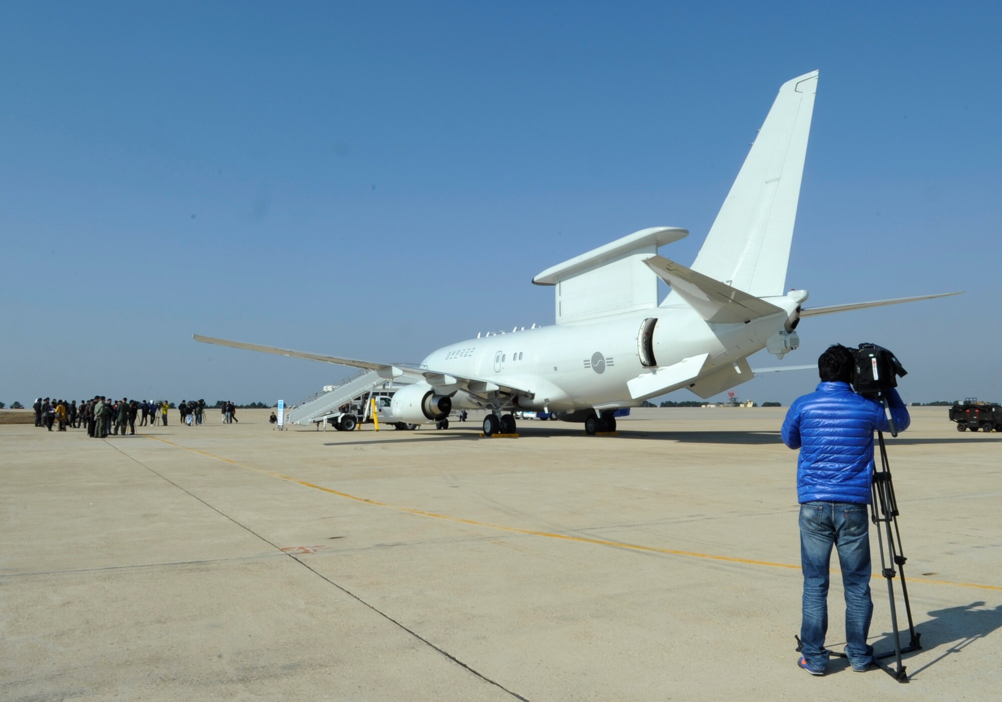 Kim Yong Ho, Associated Press TV correspondent, gathers footage of the E-737 Peace Eye aircraft during Max Thunder 12-2 Oct. 31, 2012, at Kunsan Air Base, Republic of Korea. The E-737 can fire flares, evade heat-seeking missiles and track up to 1,000 aircraft. (U.S. Air Force photo/Senior Airman Brigitte N. Brantley)