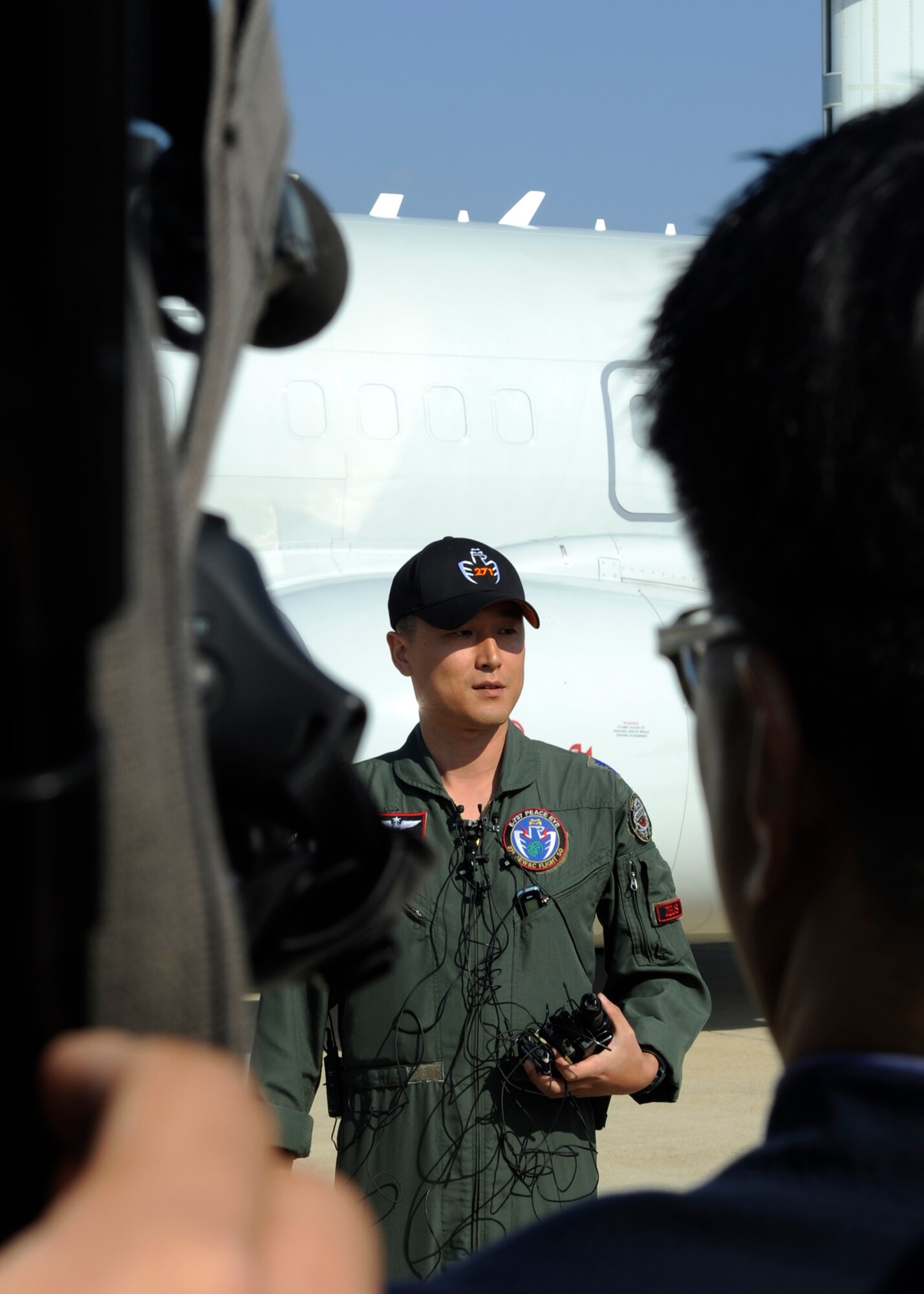 Maj. Ryu Jae Sung, 271st Airborne Early Warning and Control Flight Squadron pilot, talks to South Korean media members during Max Thunder 12-2 about the E-737 Peace Eye aircraft Oct. 31, 2012, at Kunsan Air Base, Republic of Korea. Armed with a multi-mode electronically scanned array, the E-737 has a 250-mile surveillance range and can monitor 1,000 aircraft while tracking 300 targets and scanning for low-flying aircraft. (U.S. Air Force photo/Senior Airman Brigitte N. Brantley)