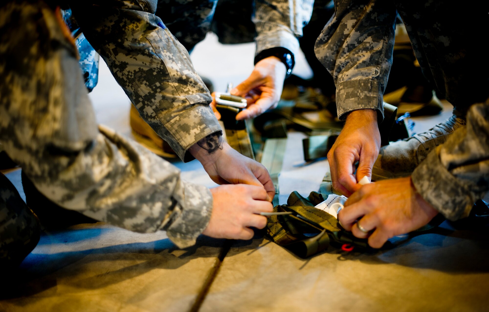 YOKOTA AIR BASE, Japan -- Army Airborne soldiers from Okinawa, Japan, prepare a parachute at Yokota Air Base, Japan, Oct. 30, 2012. The soldiers spent a week working on their parachute qualifications practicing static line jumps as well as high-altitude, low-opening jumps. (U.S. Air Force photos by Staff Sgt. Stacy Moless)