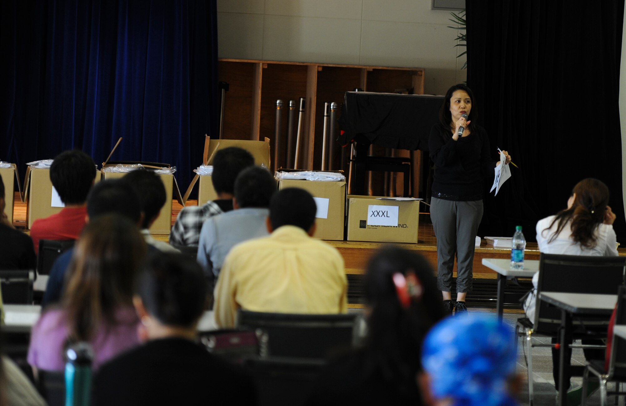 Makiko Miyara, 18th Wing Public Affairs community relations specialist, talks to the participants during the preparation for the Kadena Special Olympics at the Schilling Community Center on Kadena Air Base, Japan, Nov. 2, 2012. More than 1,300 t-shirt packages are were made for the athletes; each package includes a t-shirt, number tag and a description of events of the KSO. (U.S. Air Force photo/Airman 1st Class Justin Veazie)