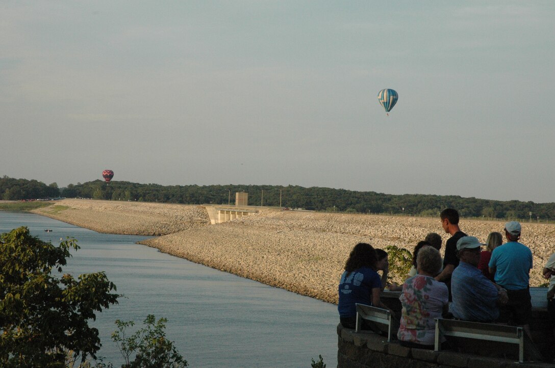 Visitors watch hot air balloons from visitor center patio