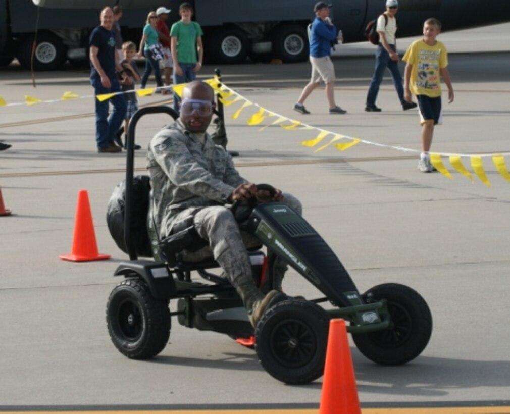 An airman tries out the pedal car obstacle course while wearing goggles that impair vision. The activity demonstrated the effects of alcohol on the body and encouraged people not to drink alcohol while boating. It was one of many interactive and educational activities that were a part of the U.S. Army Corps of Engineers Southwestern Division’s water safety event at the McConnell Air Force Base Air Show and Open House Sept. 29 & 30 in Wichita, Kansas.