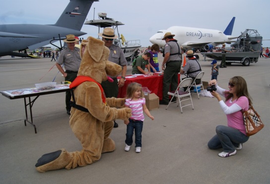 A youngster gets her picture taken with the U.S. Army Corps of Engineers water safety mascot, Bobber. She and her mother were visiting the USACE water safety event held as part of the McConnell Air Force Base Air Show and Open House in Wichita, Kansas Sept. 29 & 30.