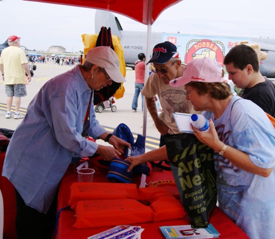 A life jacket display was one of the features at the Southwestern Division water safety event at the McConnell Air Force Base Air Show and Open House in Wichita, Kansas Sept. 29 & 30. Here, Brenda Warren, USACE Southwestern Division Safety Officer, explains the importance of always wearing a U.S. Coast Guard approved life jacket and where to look on the jacket for the rating. Warren brought a wide selection of jackets to the event to show that there is a comfortable style for every water-related activity. 