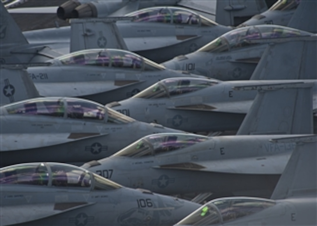 U.S. Navy F/A-18 Super Hornets are parked close together on the flight deck of the aircraft carrier USS Enterprise (CVN 65) as the ship operates in the Atlantic Ocean on Oct. 30, 2012.  The Enterprise is completing its final scheduled deployment to the 5th Fleet and 6th Fleet areas of responsibility in support of maritime security operations and theater security cooperation efforts.  