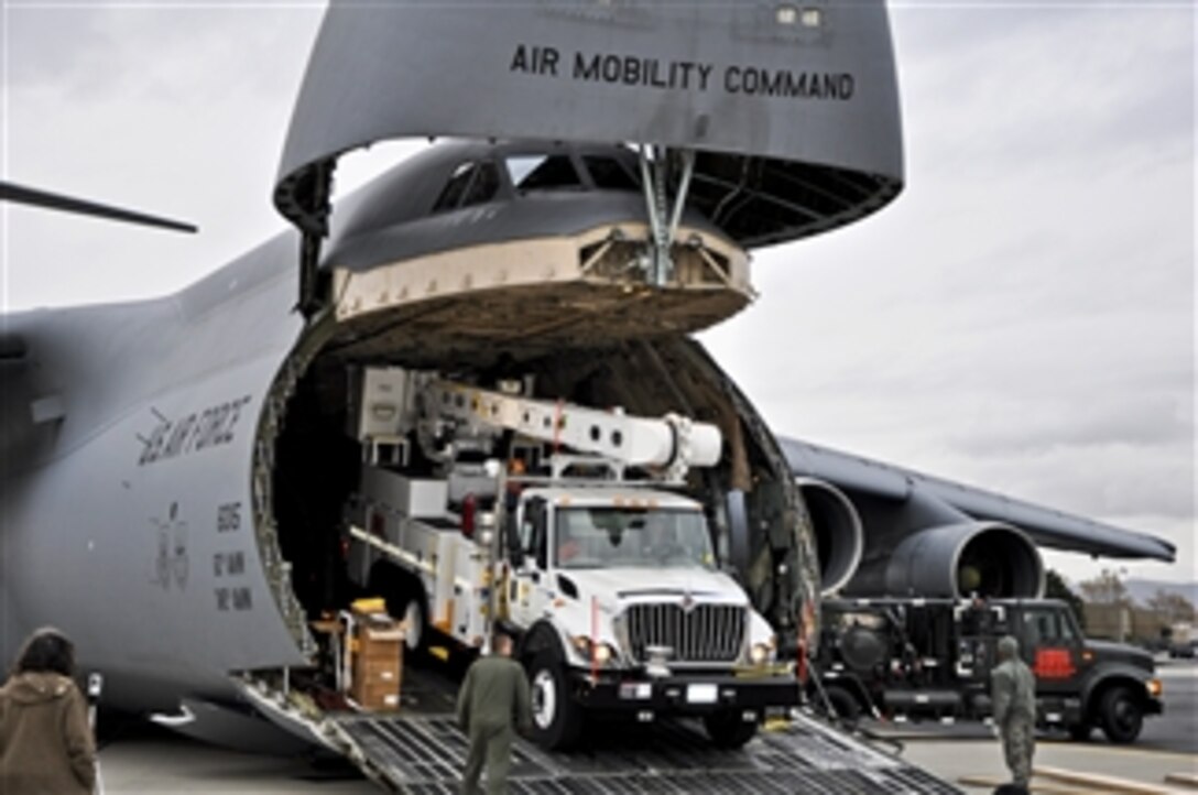 U.S. Air Force airmen unload power repair equipment belonging to Southern California Edison from a C-5 Galaxy aircraft at Stewart Air National Guard Base in Newburgh, N.Y., on Nov. 1, 2012.  The Department of Defense initiated the airlift operation to aid recovery efforts in Hurricane Sandy's aftermath.  