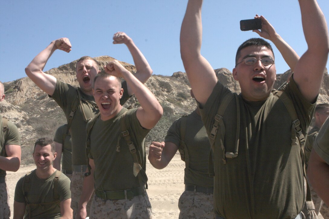 Marines with Marine Heavy Helicopter Squadron 462 cheer on their team during HMH-462 Warriors Night on Gold Beach aboard Marine Corps Base Camp Pendleton, Calif., Sept. 27. The teams competed in grappling, water grappling and kettle bell tossing.   