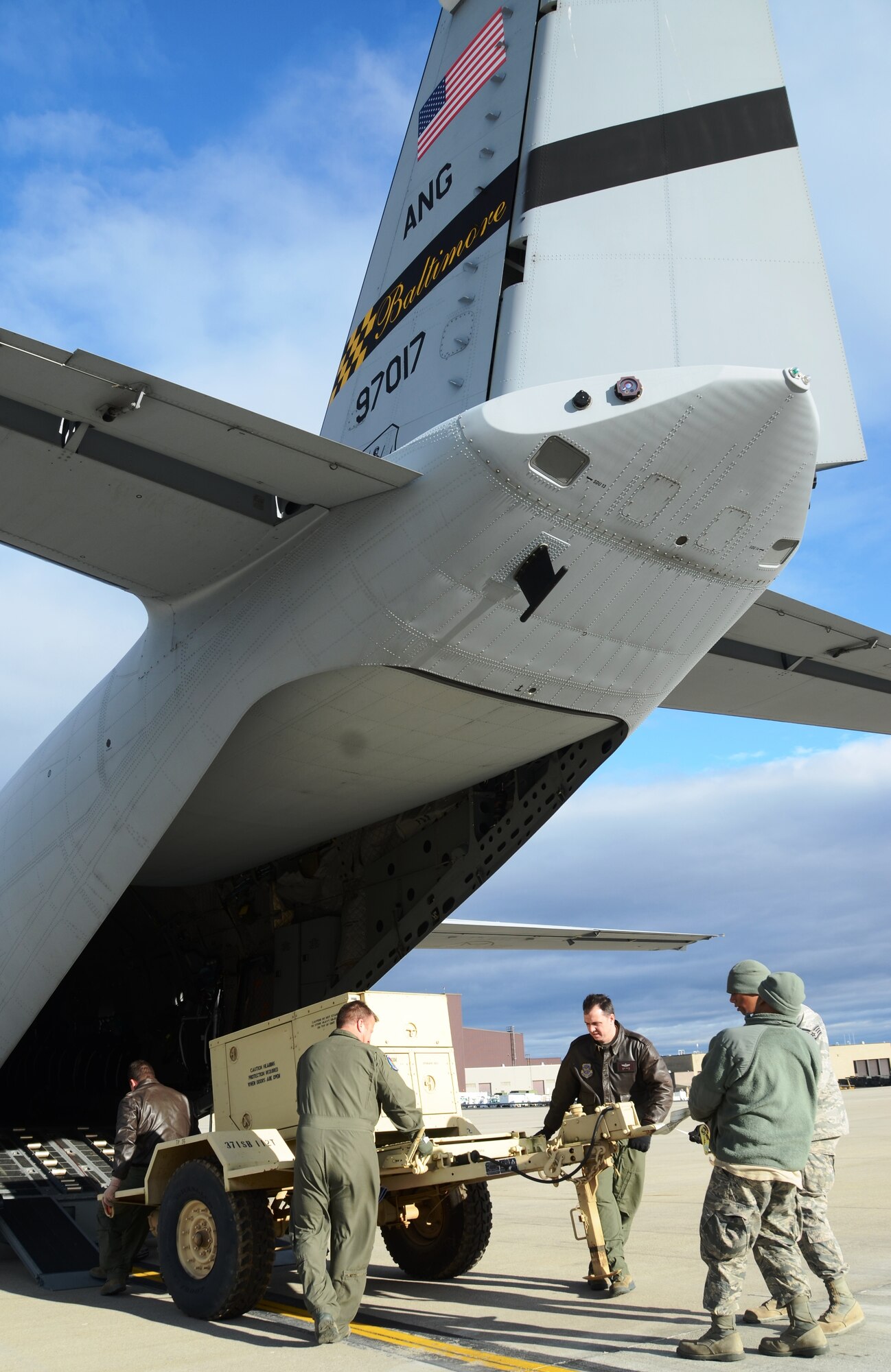 Master Sgt. Matt Kerstetter, left, and members of the New York Air National Guard unload an electrical generator from a C-27J Spartan at Stewart Air National Guard Base in New York on Saturday, November 3, 2012. The mission critical equipment is being transported by the Maryland Air National Guard for relief efforts in New York City due to Hurricane Sandy. (National Guard photo by Tech. Sgt. David Speicher)