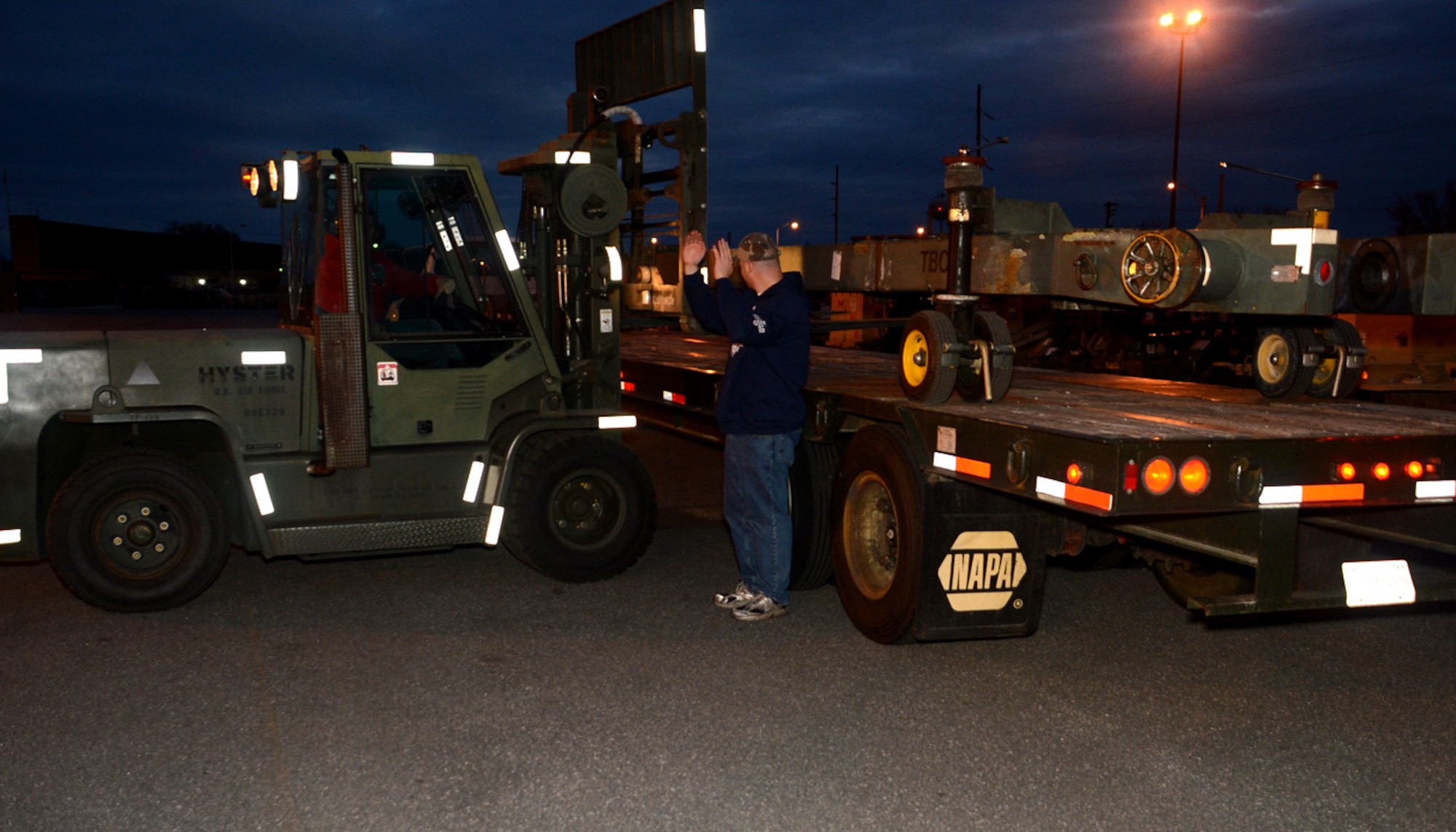 Members of the 436th Aerial Port and Logistic Readiness Squadrons load a tow bar onto a flat-bed truck Nov. 3, 2012, at Dover Air Force Base, Del. The tow bar will be transported to the John F. Kennedy International Airport and used by maintenance personnel in support of U.S. Northern Command hurricane relief operations in New York. (U.S. Air Force photo by Tech. Sgt. Chuck Walker)