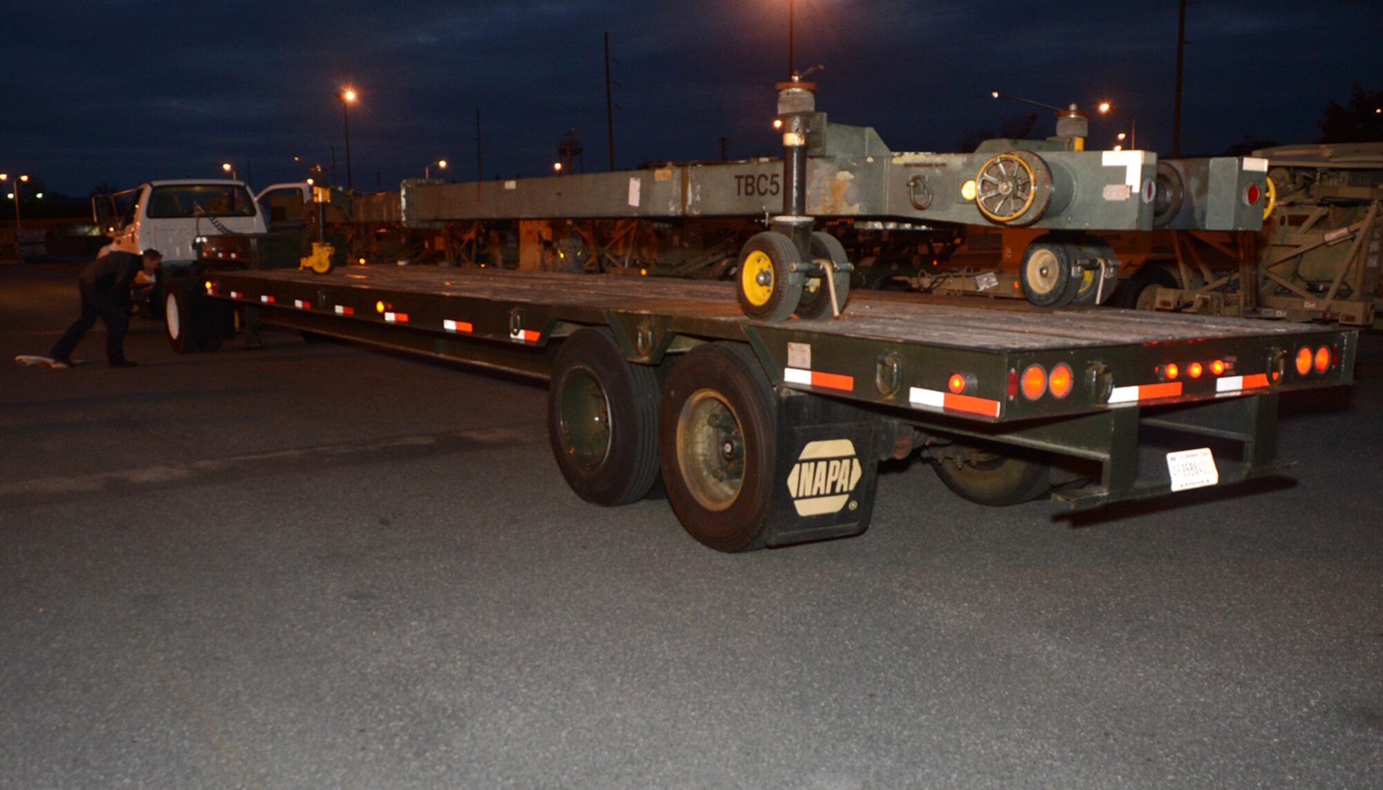 Members of the 436th Aerial Port and Logistic Readiness Squadrons load a tow bar onto a flat-bed truck Nov. 3, 2012, at Dover Air Force Base, Del. The tow bar will be transported to the John F. Kennedy International Airport and used by maintenance personnel in support of U.S. Northern Command hurricane relief operations in New York. (U.S. Air Force photo by Tech. Sgt. Chuck Walker)