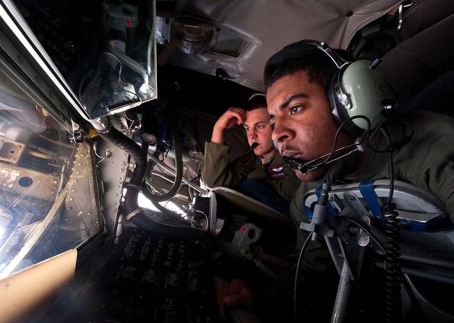 Airman 1st Class Adrian Snelson, 384th Air Refueling Squadron boom operator, McConnell Air Force Base, Kan., waits to refuel aircraft as Staff Sgt. Cody Beverly, 350th ARS boom operator, McConnell AFB, Kan., evaluates, during the Green Flag-West 13-2 exercise Nov. 1, 2012. A typical Green Flag exercise involves two multi-role fighter and/or bomber squadrons, unmanned aircraft, electronic warfare aircraft, and aerial refueling aircraft. (U.S. Air Force photo by Staff Sgt. Christopher Hubenthal)