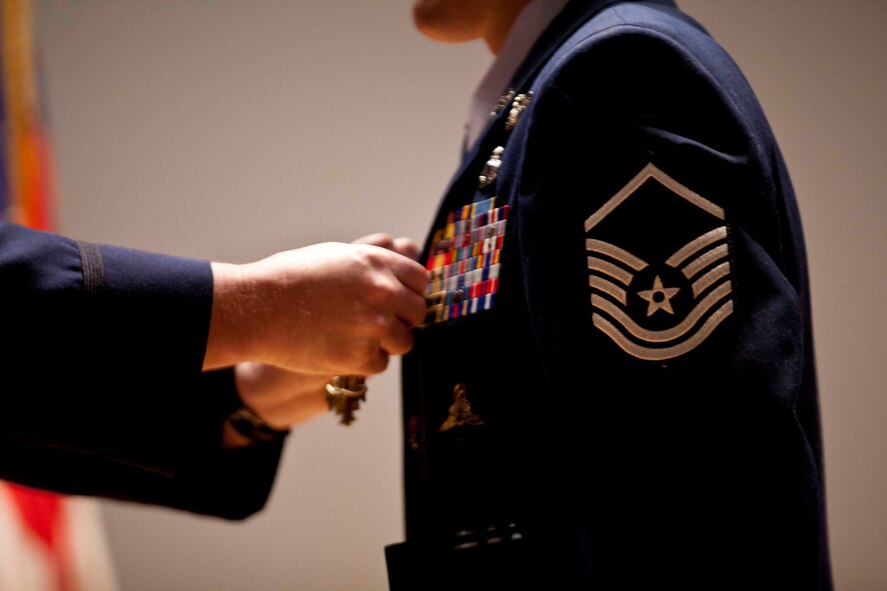 Master Sgt. Brandon Stuemke receives his Distinguished Flying Cross with Valor Nov. 3 from 212th Rescue Squadron Commander Maj. Joe Conroy for actions performed during his deployment in 2010. Stuemke conducted more than 20 missions in 5 days, including treating a fellow pararescueman from a gunshot wound while under enemy fire. Photo by Lt. Bernie Kale, Alaska National Guard Public Affairs Office