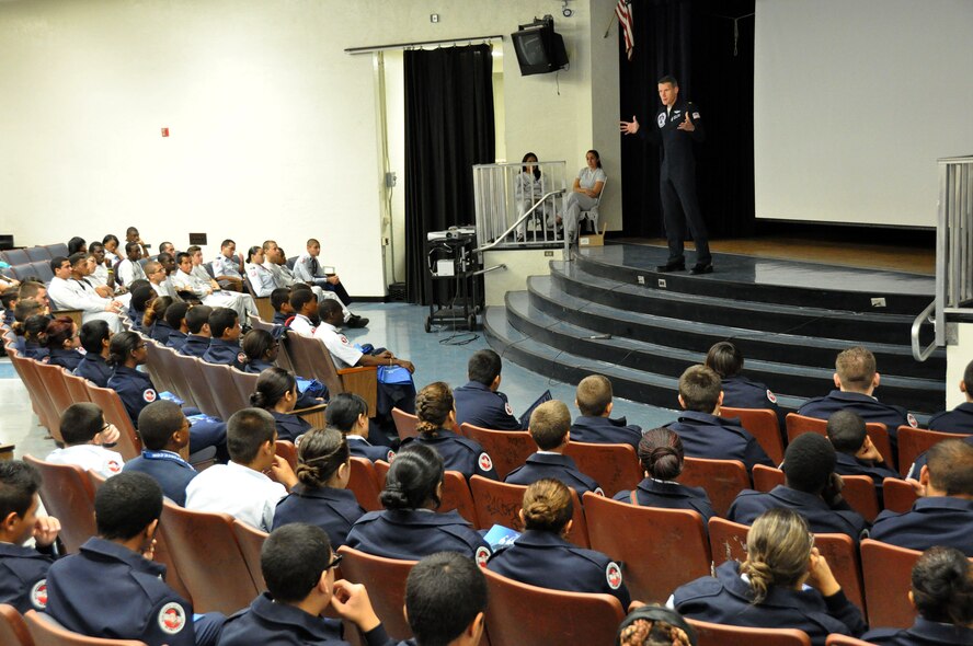 Maj. Blaine Jones, U.S. Air Force Thunderbird pilot, speaks to Air Force Junior ROTC students about being a Thunderbird at Homestead Senior High School, Nov. 2. Members of the Thunderbirds have visited several locations throughout South Florida during their time here prior to the Wings Over Homestead air show, Nov. 3 and 4. (U.S. Air Force photo/Ross Tweten)