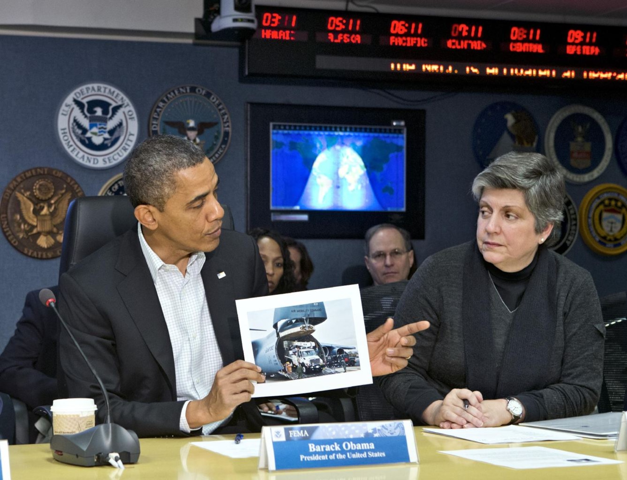 President Barack Obama briefs Secretary of Homeland Security Janet Napolitano and the Federal Emergency Management Agency on the relief efforts by the Mobility Air Forces. Aircraft and crews from 12 active duty, Air National Guard, and Air Force Reserve bases across the nation were mobilized to deliver equipment and supplies supporting to Stewart Air National Guard Base, N.Y., to assist with the relief efforts on the East Coast. (Courtesy Photo)