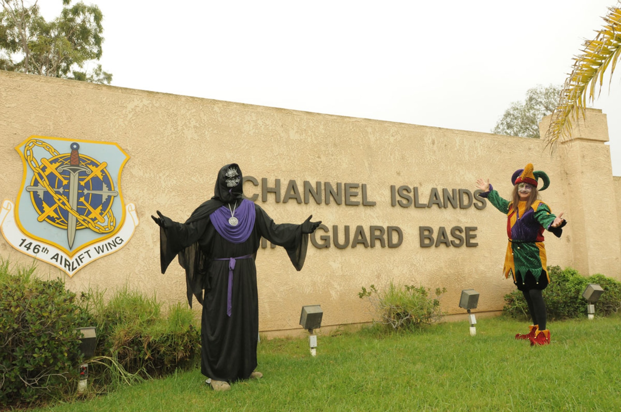 The Emperor of Evil (Col. Hargrove) and his evil court jester (Chief
Onsgard) greet guests at the front gate of the 146th Airlift Wing, Halloween
2012. (photo by: Master Sgt. David Buttner)
