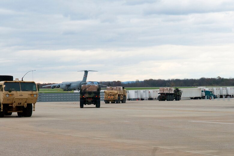 Three trucks, operated by the 77th Brigade’s  201st  Forward Support Company,  head off the ramp at the 167th Airlift Wing, Martinsburg, W.Va., Nov.2, 2012. The trucks, full of boxed meals, were destined for Tucker County, W.Va., one of the W.Va. counties with heavy snow and power outages. The 167th AW is serving as a staging area for disaster relief supplies which will then be transported throughout West Virginia as needed. The West Virginia National Guard has over 200 members aiding in recovery efforts from Hurricane Sandy.  The storm blanketed the state with heavy snow and rains and also had severe winds that left homes and properties damaged.  Guardsmen are involved in numerous aspects of the operations from search and rescue missions to debris removal. (Air National Guard photo by Master Sgt. Emily Beightol-Deyerle)