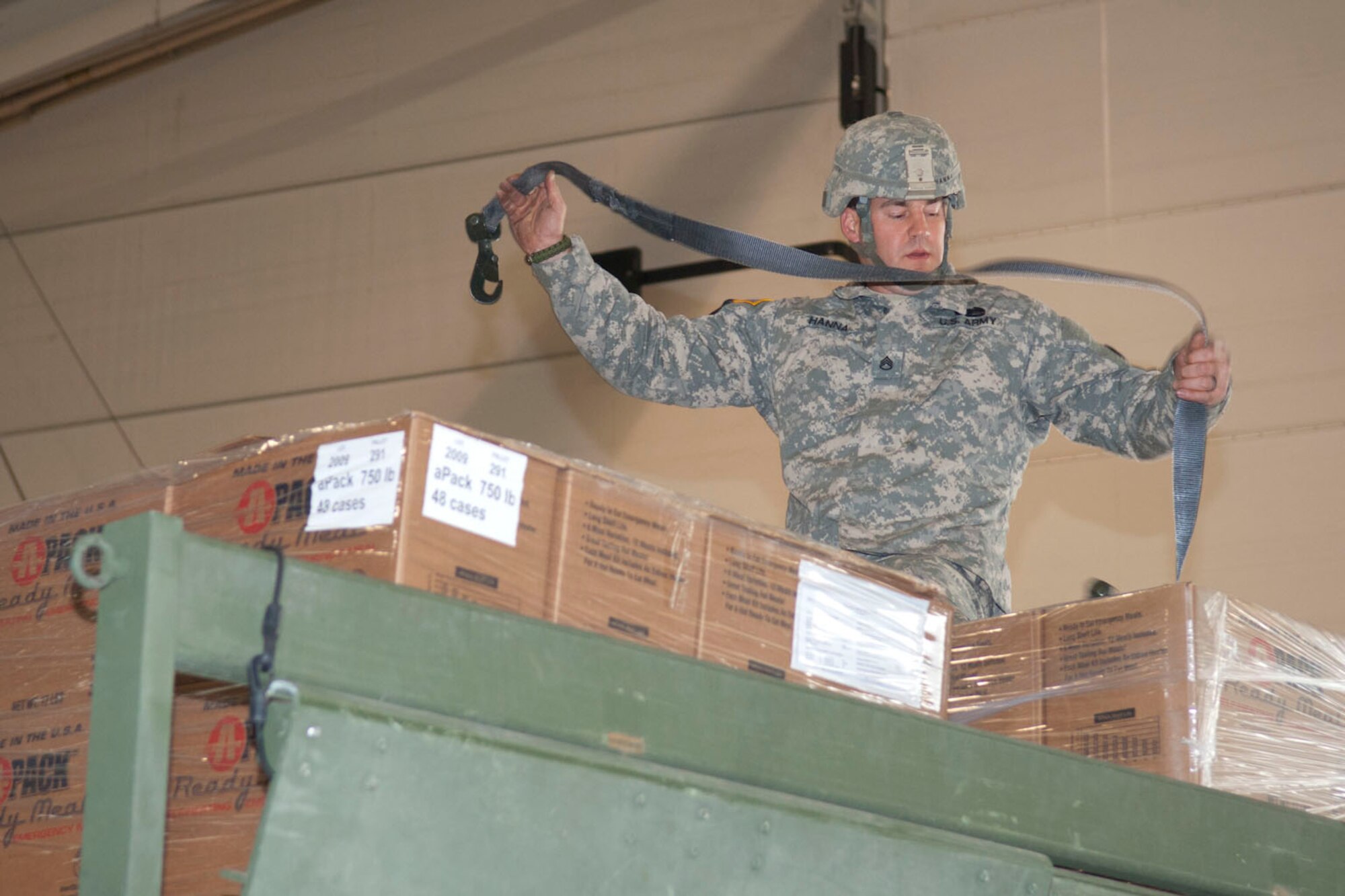 West Virginia National Guardsman, Staff Sgt. Robert Hanna, assigned to the 77th Brigade’s 201st Forward Support Company, straps down pallets of boxed ready-to-eat meals on a truck in a hangar at the 167th Airlift Wing, Martinsburg, W.Va., Nov.2, 2012. The truck was destined for Tucker County, W.Va., one of the W.Va. counties with heavy snow and power outages. The 167th AW is serving as a staging area for disaster relief supplies which will then be transported throughout West Virginia as needed. The West Virginia National Guard has over 200 members aiding in recovery efforts from Hurricane Sandy.  The storm blanketed the state with heavy snow and rains and also had severe winds that left homes and properties damaged.  Guardsmen are involved in numerous aspects of the operations from search and rescue missions to debris removal. (Air National Guard photo by Master Sgt. Emily Beightol-Deyerle)