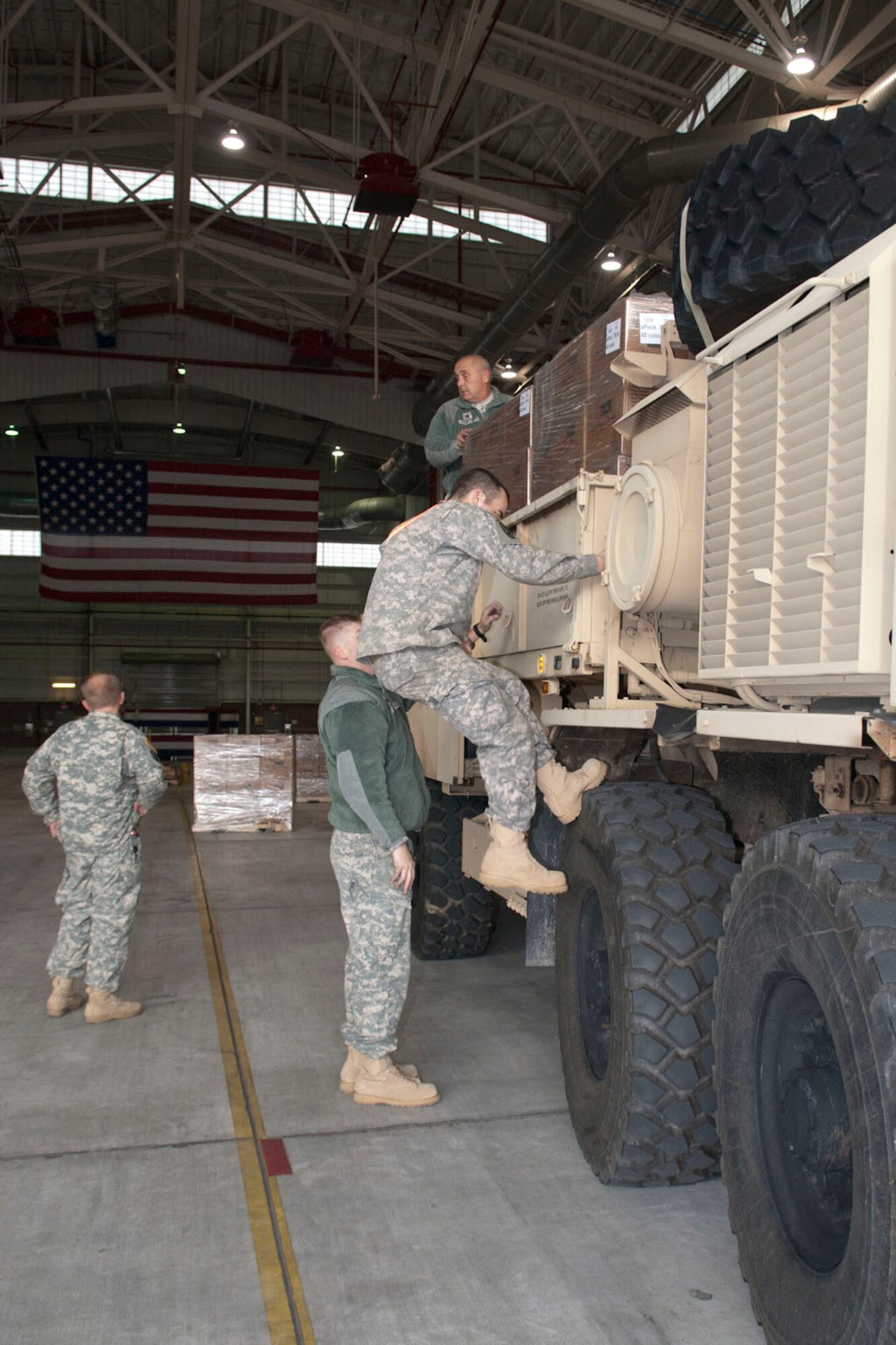 West Virginia National Guardsmen with the 77th Brigade’s 201st Forward Support Company and 1201st FSC make final preparations to a truck at the 167th Airlift Wing, Martinsburg, W.Va., Nov.2, 2012.The truck, full of boxed ready-to-eat meals, was destined for Tucker County, W.Va., one of the W.Va. counties with heavy snow and power outages. The 167th AW is serving as a staging area for disaster relief supplies which will then be transported throughout West Virginia as needed. The West Virginia National Guard has over 200 members aiding in recovery efforts from Hurricane Sandy.  The storm blanketed the state with heavy snow and rains and also had severe winds that left homes and properties damaged.  Guardsmen are involved in numerous aspects of the operations from search and rescue missions to debris removal. (Air National Guard photo by Master Sgt. Emily Beightol-Deyerle)