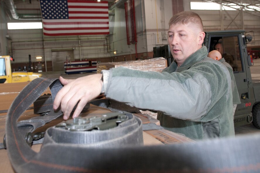West Virginia National Guardsmen, Sgt. Gabriel Stone, 77th Brigade’s 1201st Forward Support Company, ties down pallets on a truck inside a hangar at the 167th Airlift Wing, Martinsburg, W.Va., Nov. 2, 2012. The 167th AW is serving as a staging area for disaster relief supplies which will then be transported throughout West Virginia as needed. The West Virginia National Guard has over 200 members aiding in recovery efforts from Hurricane Sandy.  The storm blanketed the state with heavy snow and rains and also had severe winds that left homes and properties damaged.  Guardsmen are involved in numerous aspects of the operations from search and rescue missions to debris removal. (Air National Guard photo by Master Sgt. Emily Beightol-Deyerle)