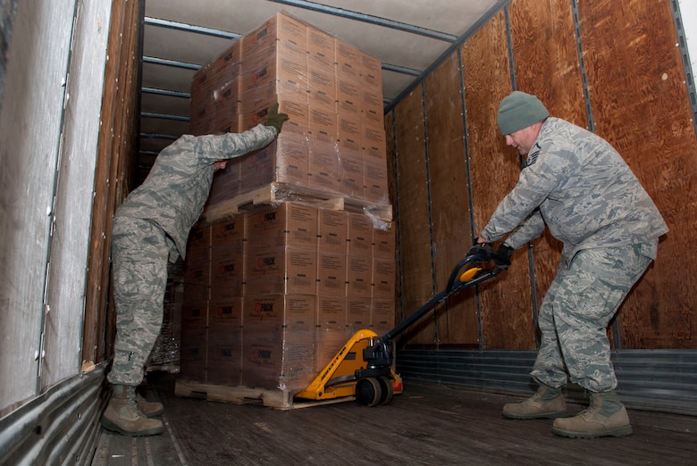 Airmen with the 167th Airlift Wing’s small air terminal maneuver pallets of boxed meals on a trailer at the unit based in Martinsburg W.Va., Thursday Nov. 2, 2012. The 167th AW is serving as a staging area for disaster relief supplies which will then be transported throughout West Virginia as needed. The West Virginia National Guard has over 200 members aiding in recovery efforts from Hurricane Sandy.  The storm blanketed the state with heavy snow and rains and also had severe winds that left homes and properties damaged.  Guardsmen are involved in numerous aspects of the operations from search and rescue missions to debris removal. (Air National Guard photo by Master Sgt. Emily Beightol-Deyerle)