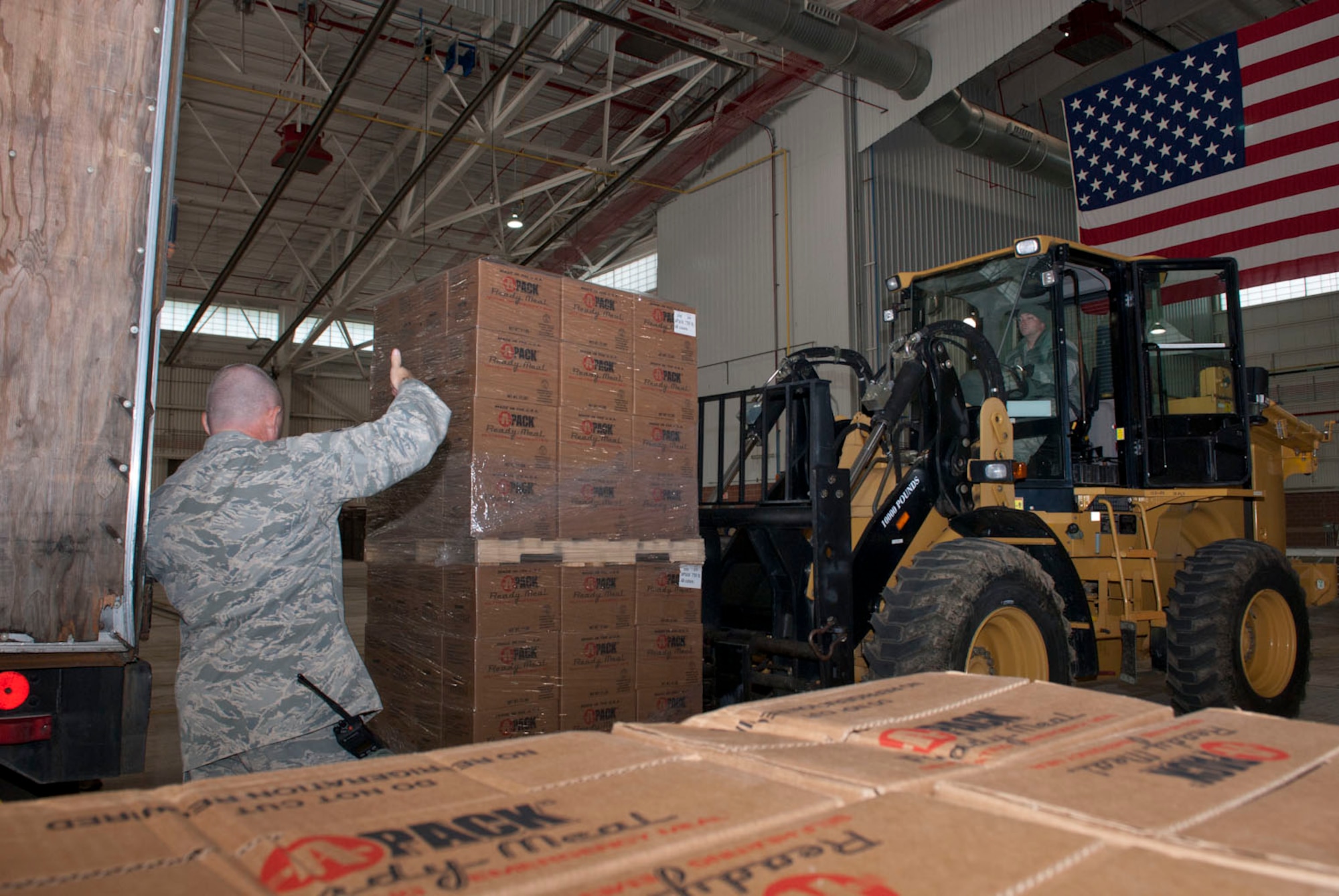 Airmen with the 167th Airlift Wing’s small air terminal move pallets of boxed meals off of a trailer at the unit based in Martinsburg W.Va., Thursday Nov. 2, 2012. The 167th AW is serving as a staging area for disaster relief supplies which will then be transported throughout West Virginia as needed. The West Virginia National Guard has over 200 members aiding in recovery efforts from Hurricane Sandy.  The storm blanketed the state with heavy snow and rains and also had severe winds that left homes and properties damaged.  Guardsmen are involved in numerous aspects of the operations from search and rescue missions to debris removal. (Air National Guard photo by Master Sgt. Emily Beightol-Deyerle)
