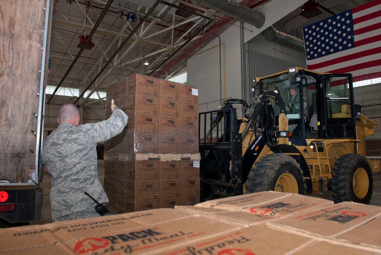 Airmen with the 167th Airlift Wing’s small air terminal move pallets of boxed meals off of a trailer at the unit based in Martinsburg W.Va., Thursday Nov. 2, 2012. The 167th AW is serving as a staging area for disaster relief supplies which will then be transported throughout West Virginia as needed. The West Virginia National Guard has over 200 members aiding in recovery efforts from Hurricane Sandy.  The storm blanketed the state with heavy snow and rains and also had severe winds that left homes and properties damaged.  Guardsmen are involved in numerous aspects of the operations from search and rescue missions to debris removal. (Air National Guard photo by Master Sgt. Emily Beightol-Deyerle)