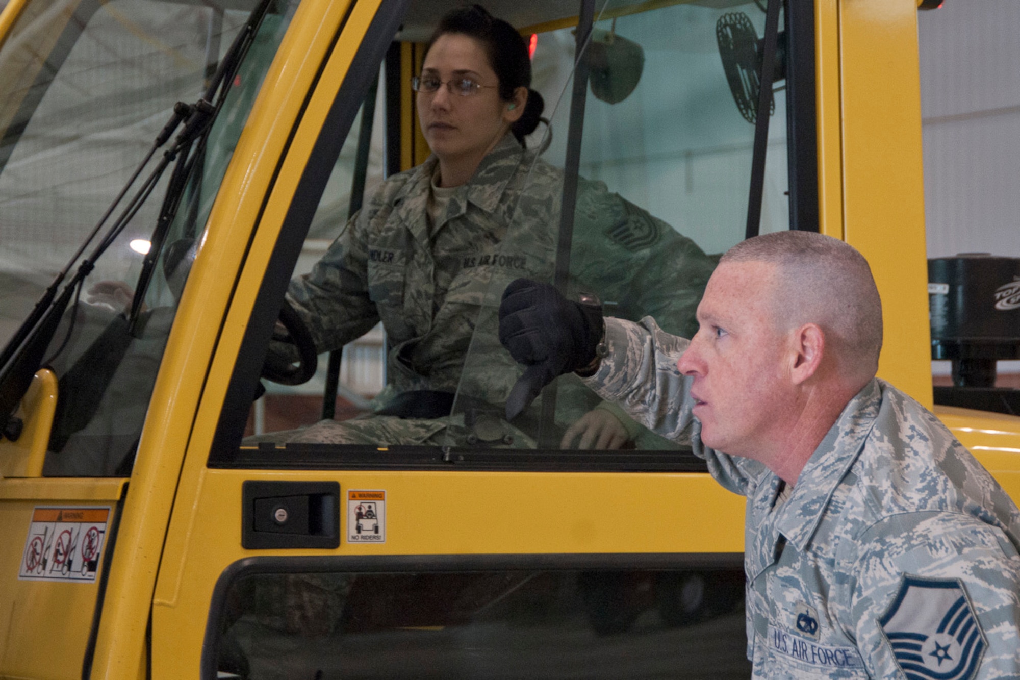 Master Sgt. Jodi Miller signals to Tech. Sgt. Jackquelyn Wandler as she maneuvers pallets off of a FEMA trailer at the 167th Airlift Wing, West Virginia Air National Guard, based in Martinsburg W.Va., Thursday Nov. 1, 2012. The 167th AW is serving as a staging area for disaster relief supplies which will then be transported throughout West Virginia as needed. The West Virginia National Guard has over 200 members aiding in recovery efforts from Hurricane Sandy.  The storm blanketed the state with heavy snow and rains and also had severe winds that left homes and properties damaged.  Guardsmen are involved in numerous aspects of the operations from search and rescue missions to debris removal. (Air National Guard photo by Master Sgt. Emily Beightol-Deyerle)