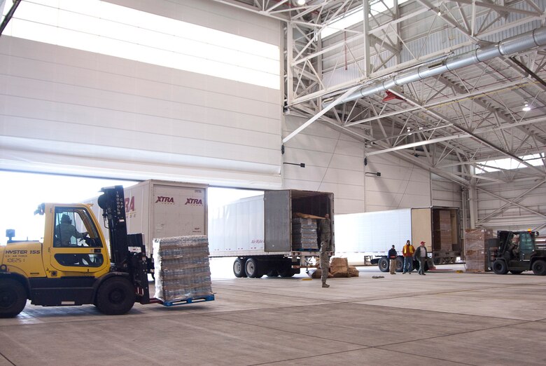 Trucks full of FEMA disaster relief supplies are unloaded in a hangar at the 167th Airlift Wing, West Virginia Air National Guard, based in Martinsburg W.Va., Thursday Nov. 1, 2012. The 167th AW is serving as a staging area for disaster relief supplies which will then be transported throughout West Virginia as needed. The West Virginia National Guard has over 200 members aiding in recovery efforts from Hurricane Sandy.  The storm blanketed the state with heavy snow and rains and also had severe winds that left homes and properties damaged.  Guardsmen are involved in numerous aspects of the operations from search and rescue missions to debris removal. (Air National Guard photo by Master Sgt. Emily Beightol-Deyerle)