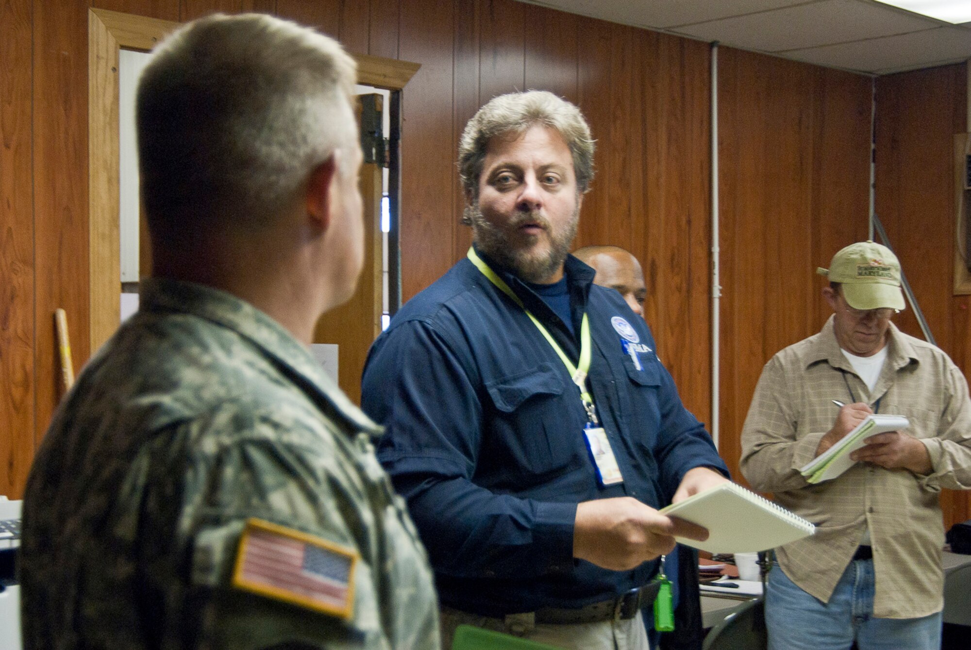Joseph D'Angelo, Joe D'Angelo, FEMA's Incident Management Assistance Team (IMAT) logistics chief for Region III comments to West Virginia National Guardsman, Master Sgt. Keith Bibb, 77th Brigade property book officer, during a meeting to coordinate operations at the 167th Airlift Wing, West Virginia Air National Guard, based in Martinsburg W.Va., Thursday Nov. 1, 2012. The 167th AW is serving as a staging area for disaster relief supplies which will then be transported throughout West Virginia by the 77th Brigade’s 1201st Forward Support Company based in Kingwood W.Va. and Delta 230th FSC based in Glen Jean, W.Va. The West Virginia National Guard has over 200 members aiding in recovery efforts from Hurricane Sandy.  The storm blanketed the state with heavy snow and rains and also had severe winds that left homes and properties damaged.  Guardsmen are involved in numerous aspects of the operations from search and rescue missions to debris removal. (Air National Guard photo by Master Sgt. Emily Beightol-Deyerle)