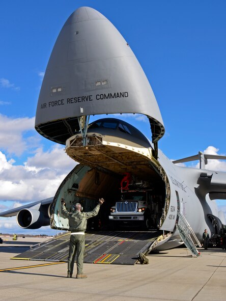 In response to President Obama's call for the government to support Hurricane Sandy relief efforts, a Westover C-5B flew to March Air Reserve Base, Calif., picked up 73 electrical workers and two utility trucks, and dropped them off at Stewart Air National Guard Base, near New York City, hours later. (U.S. Air Force photo/SrA. Kelly Galloway)