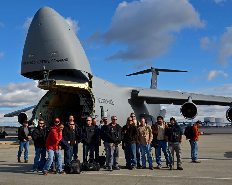 In response to President Obama's call for the government to support Hurricane Sandy relief efforts, a Westover C-5B flew to March Air Reserve Base, Calif., picked up 73 electrical workers and two utility trucks, and dropped them off at Stewart Air National Guard Base, near New York City, hours later. (U.S. Air Force photo/SrA. Kelly Galloway)