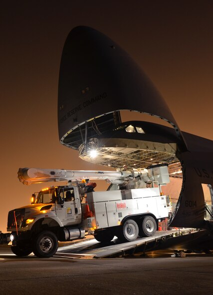 In response to President Obama's call for the government to support Hurricane Sandy relief efforts, a Westover C-5B flew to March Air Reserve Base, Calif., picked up 73 electrical workers and two utility trucks, and dropped them off at Stewart Air National Guard Base, near New York City, hours later. (U.S. Air Force photo/SrA. Kelly Galloway)