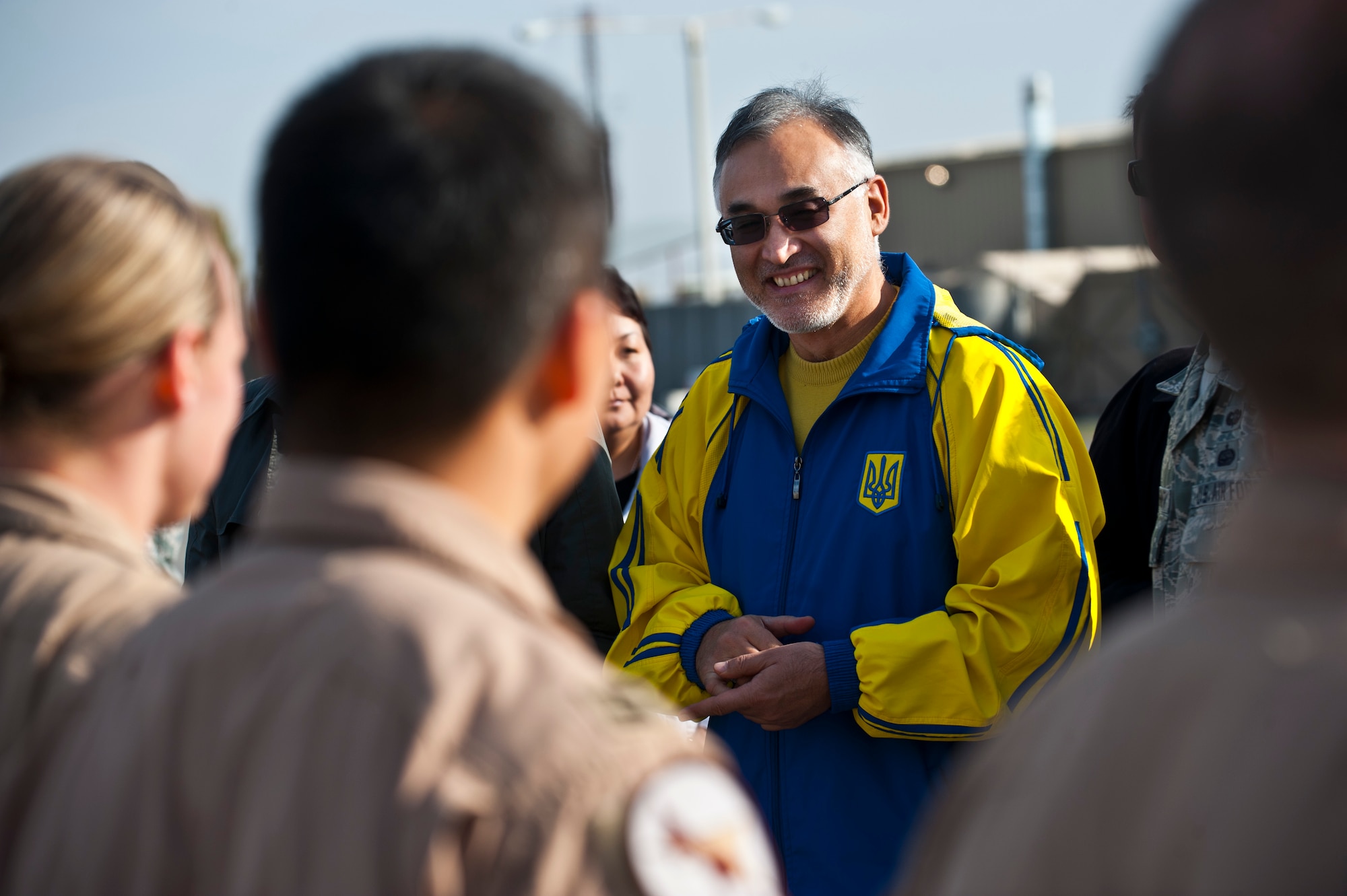 Tursunbay Bakir Uulu speaks with 22nd Expeditionary Air Refueling Squadron Airmen before a air refueling demonstration at the Transit Center at Manas, Kyrgyzstan, Nov. 2, 2012. Kyrgyz Republic Parliamentarians visited to learn about the Transit Center's mission set and the U.S. Air Force air refueling capabilities. Uulu is a member of the Kyrgyz Republic Parliament. (U.S. Air Force photo/Senior Airman Brett Clashman)